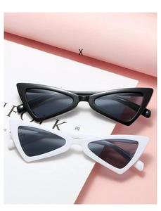 Chic black and white cat eye sunglasses with sharp triangular frames on pink background