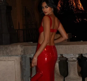 Detail of red sequined backless evening gown with a slim fit silhouette on outdoor model