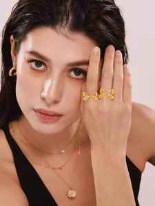 Close-up of gold butterfly multi-finger ring jewelry on a fashion model's hand