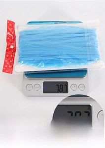 Detail shot showing a 78.7g weight measurement of blue foil fringe curtain packaging