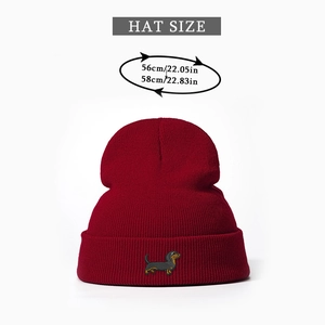 Size guide for dark red beanie featuring detailed dachshund embroidery and head measurements