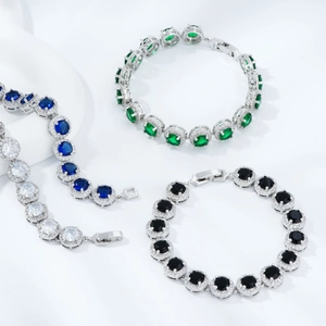 Three elegant geometric tennis bracelets with round emerald, sapphire, and onyx cubic zirconia