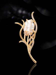 Macro shot of tulip brooch with baroque pearl and micro-paved zircons on gold metal
