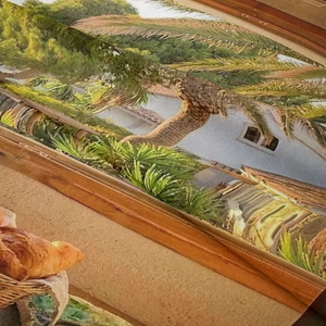 Detail showing high-density woven texture and hemmed edge of tropical landscape tapestry