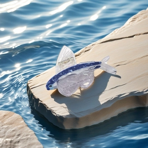 Flying fish acetate hair claw clip with blue and white pattern on a water rock