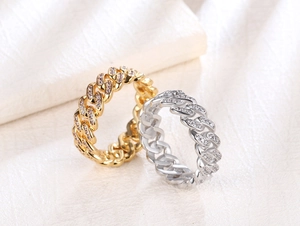 Macro detail of 8mm hip hop cuban link rings with full zircon stones in gold and silver