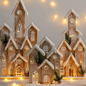 Lighted wooden Christmas house set with warm LED lights and artificial snow decor
