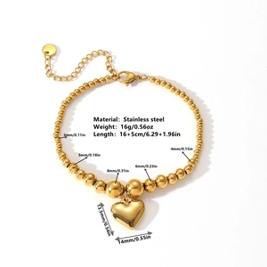 Gold stainless steel beaded heart bracelet featuring adjustable chain and polished charms