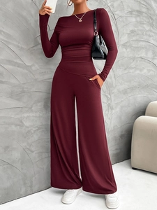 Deep red long sleeve top and wide leg trousers set shown in a stylish standing pose