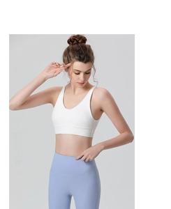 Detail shot of white V-neck sports bra with wide straps and high-elastic matte fabric