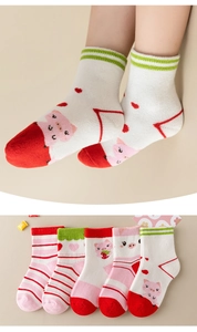 Close-up of five pairs of cotton kids socks with cute pig patterns and stripe details
