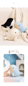 Close-up of soft whale plush toys in blue and white with detailed striped belly texture