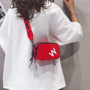 Glossy red patent leather crossbody bag with white W logo and wide lettered strap