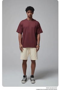 Front full view of a men's burgundy oversized cotton T-shirt with cream drawstring shorts
