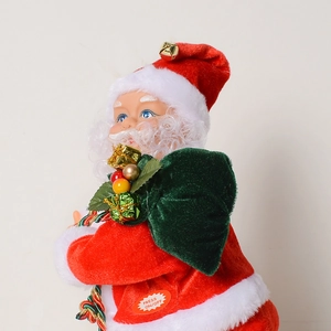 Détail du Père Noël électrique avec tissu en peluche rouge et sac cadeau vert inclus