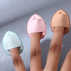 Set of three mini teardrop finger powder puffs in pink, blue, and skin-tone colors