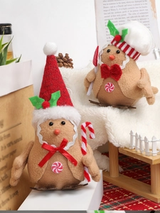 Close-up of gingerbread felt dolls with Christmas hats and candy canes for holiday decor