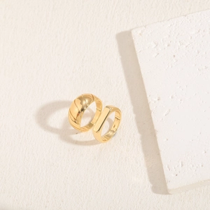 Detailed view of 14K gold plated geometric ring set with twisted rope texture and minimalist band