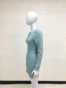 Detail of turquoise glitter mini dress showing backless design and slim fit fabric
