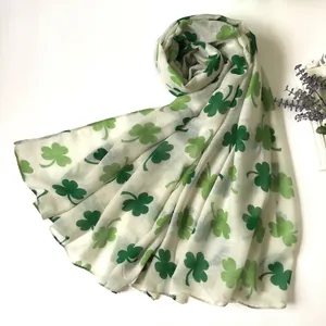 Lightweight white scarf with green clover print for Saint Patrick's Day celebration