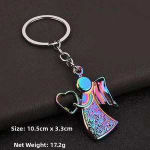 Macro shot of iridescent rainbow angel keychain with detailed feather wings and heart pose