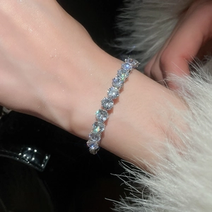 Detailed view of luxury tennis bracelet with round cubic zirconia on a wrist