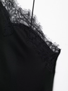 Détail de la robe en satin noir avec bordure en dentelle et texture soyeuse élégante