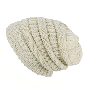 Close-up of beige knit beanie showing thick vertical ribbed texture and slouchy design