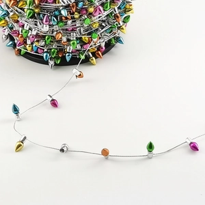 Detail of multi-colored teardrop beads on silver wire for festive Christmas decoration