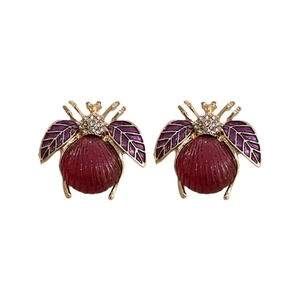 Vintage beetle stud earrings with purple enamel wings and red stone in gold plating