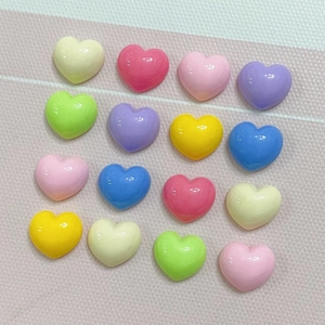 Detailed view of colorful glossy resin heart accessories for DIY crafts and hair clips