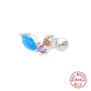 Macro shot of S925 sterling silver cartilage stud with blue and purple gemstones