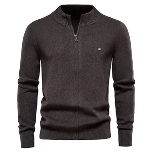 Close-up of men's dark grey knit cardigan showing fine ribbed texture and metal logo detail