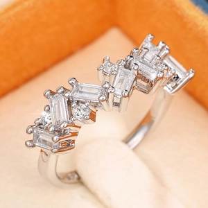 Elegant silver ring featuring rectangular and round cut clear stones in a zigzag design