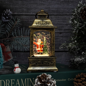 Close-up of golden vintage Christmas lantern with Santa scene and shimmering glitter