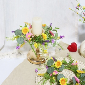 Detailed close-up of candle ring with yellow daisies, pink blossoms and lavender accents