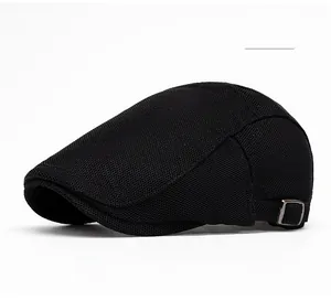 Close-up of black mesh newsboy cap texture and adjustable vintage metal side buckle