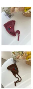 Close-up of handmade knit floral headbands with intricate embroidery and ear protection