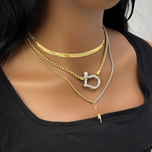 Three-layer layered necklace set with gold snake chain, carabiner link, and lightning pendant