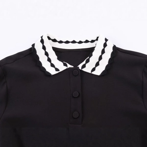 Women's black polo t-shirt featuring a wavy white trim collar and three buttons