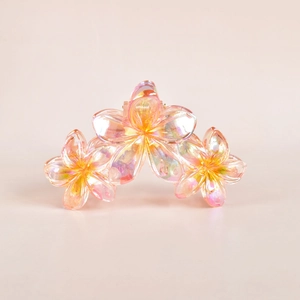 Detail of pink floral hair claw clip with translucent rainbow gloss finish for women