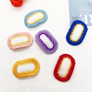 Set of six colorful handmade crochet oval hair clips on a minimalist white textured background