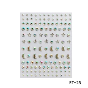 Detailed sheet of self-adhesive iridescent acrylic facial rhinestones in star and moon shapes