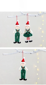 Detail of plush Christmas elf ornaments with reindeer hats and green suspenders