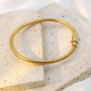 Detail of 18k gold plated tubogas snake chain bracelet with cylindrical push clasp