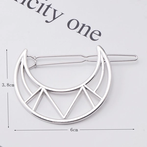 Silver crescent moon metal hair clip detail with geometric V-shape and 6cm size measurement