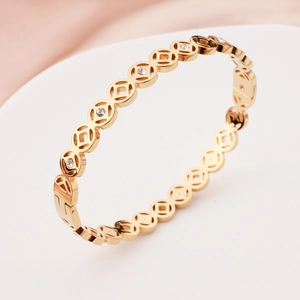 Polished gold-plated stainless steel hollow coin bracelet with white zircon inlay for women