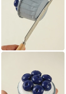 Detail of wooden handle spatula decorating artificial blueberry cupcake models