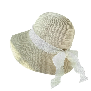 Beige straw sun hat with white lace bow detail shown from a 45-degree angle view