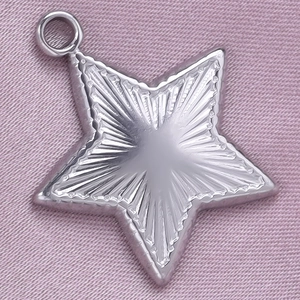 Macro view of 304 stainless steel star pendant with textured finish and beaded edges